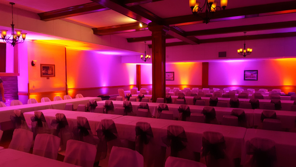 Up lighting in magenta pink and orange for a wedding at the Elks Lodge.