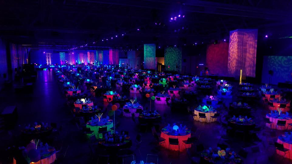 Essentia Health event at the DECC. Pioneer Hall washed in UV lighting. Decor by Event Lab