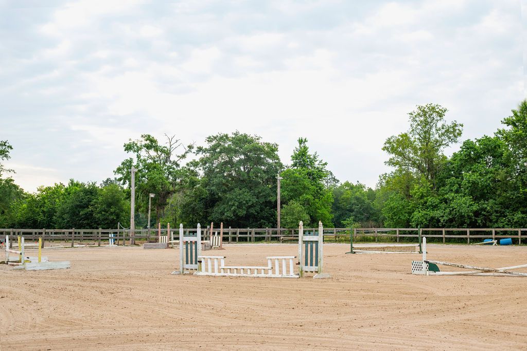 The main arena which is set up to be full jump course with an outside track to ride along the rail.