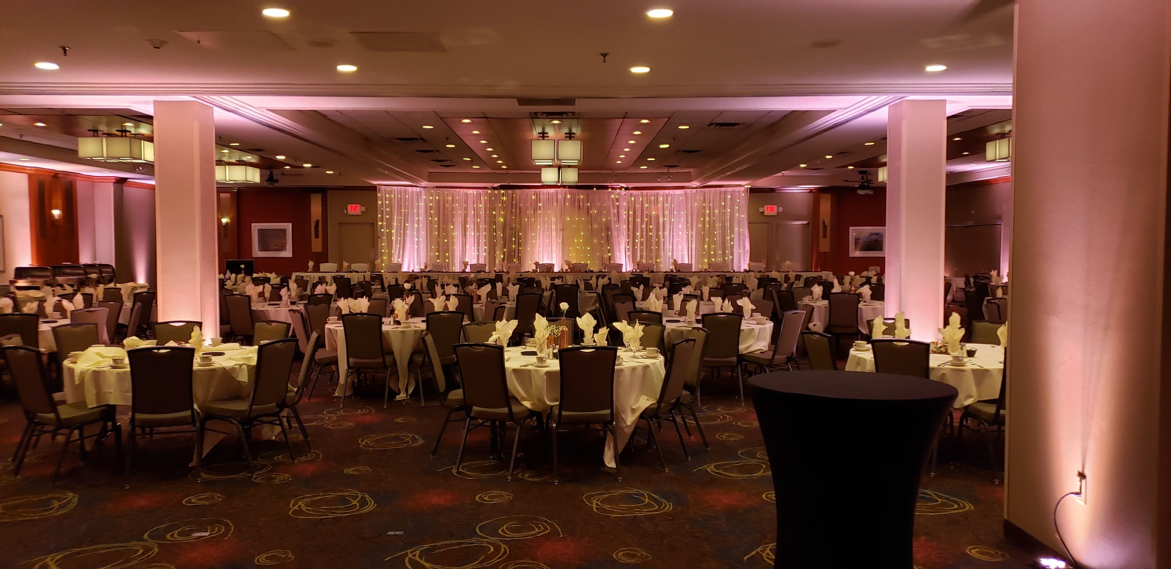 Wedding lighting at the Holiday Inn with a LED curtain backdrop behing the head table.