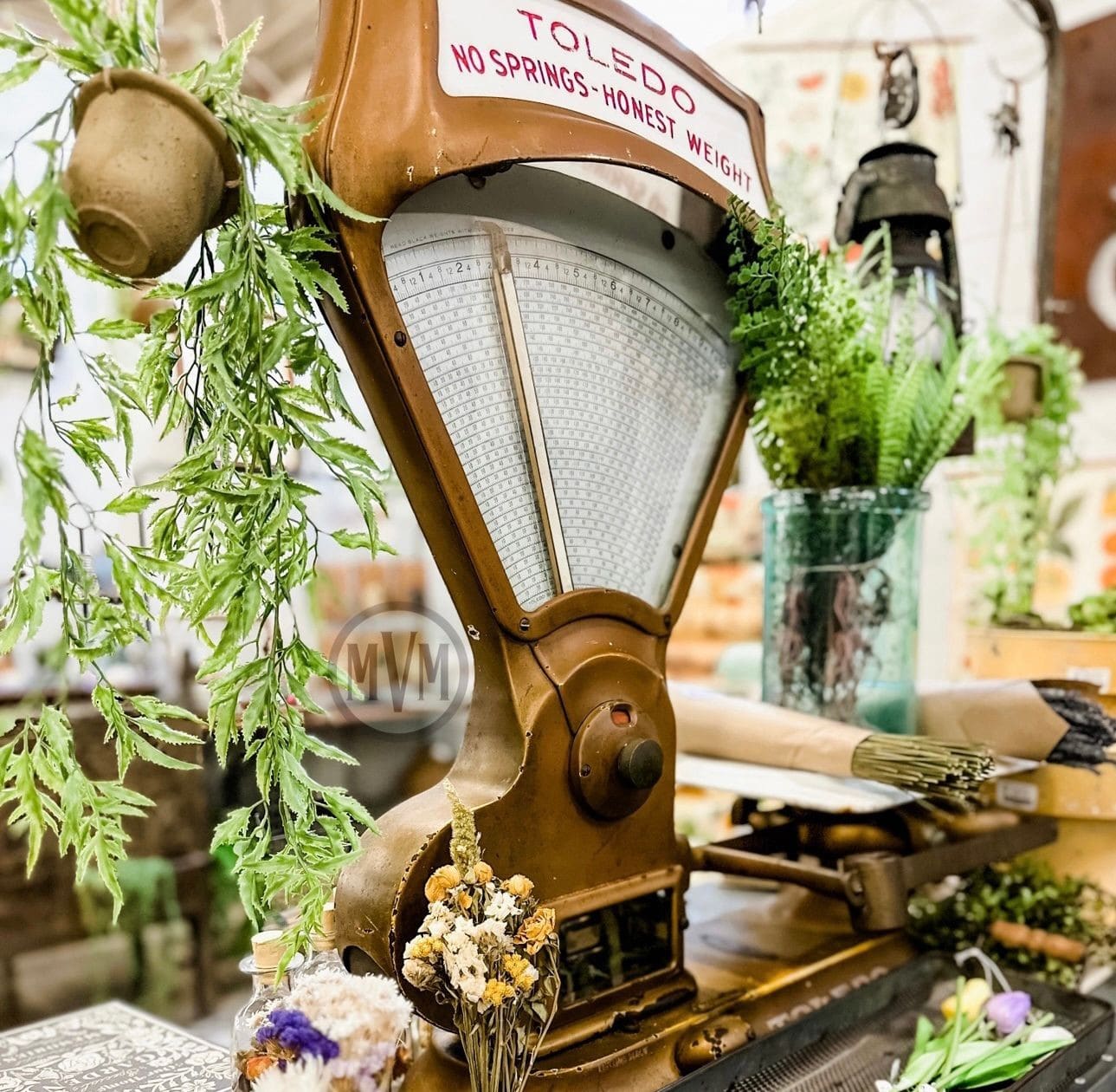 Amazing antique Toledo scale paired beautifully with garden decor andother vintage accents at a The Modern Vintage Market vendor booth