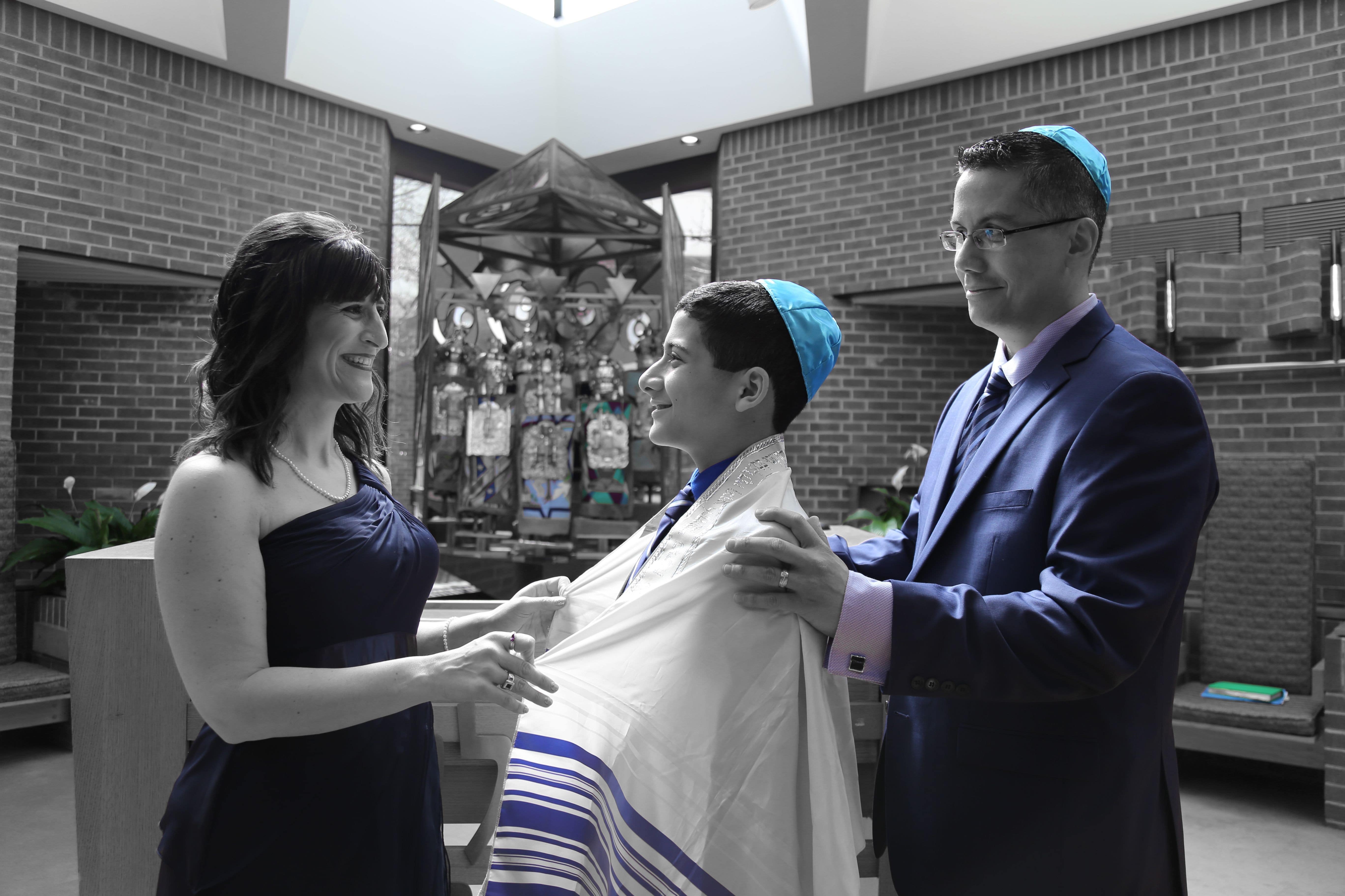 Bar Mitzvah Rehearsal Portrait Session. Mother and Father putting the ceremonial tallit on their son's shoulders. Photography by Angel at Tylerstar Productions.