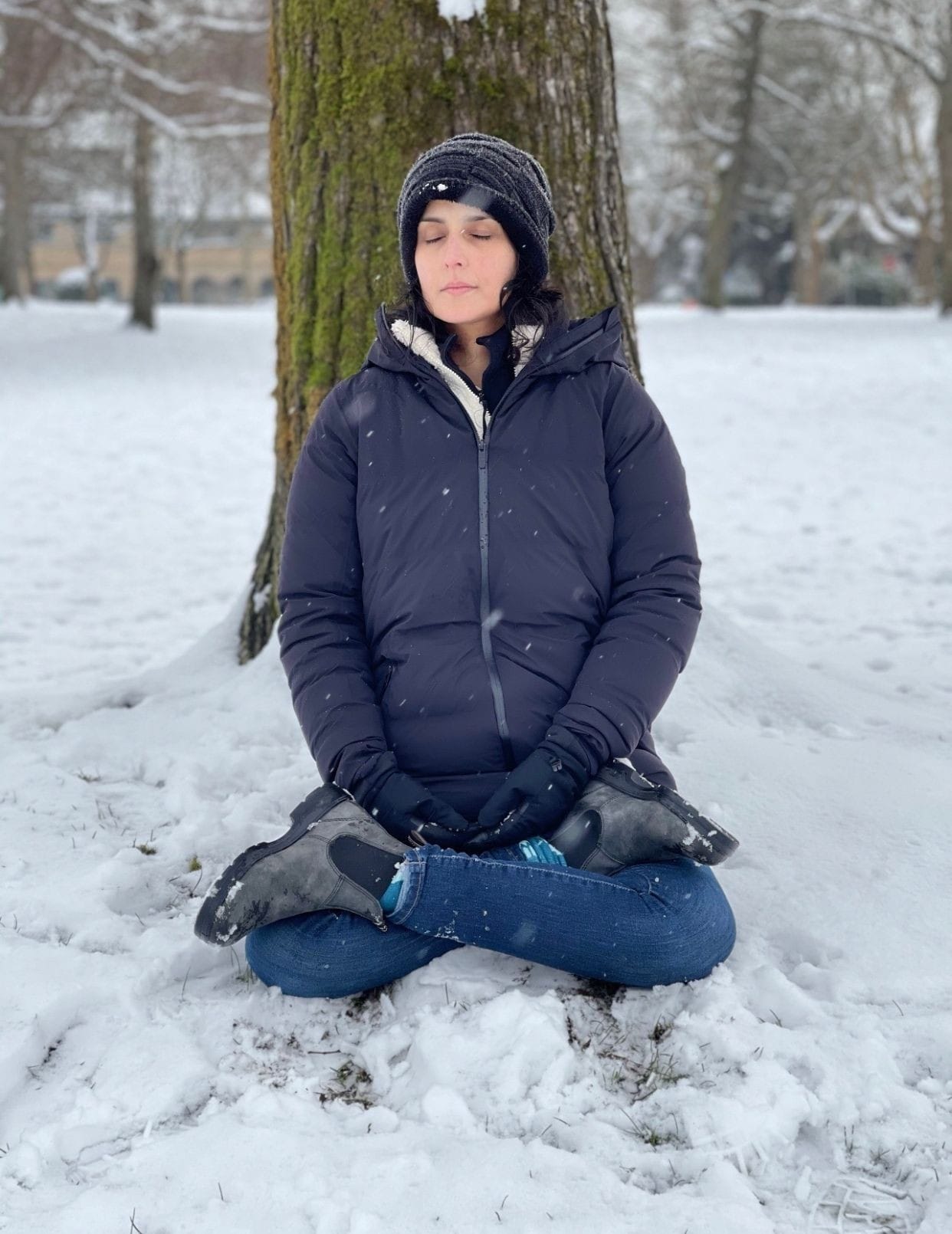 Tulip Joshi Sitting on Ground Covered with Snow
