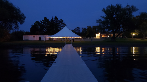 Tent wedding lighting. A tent on Pike Lake glows with perimeter bistro.