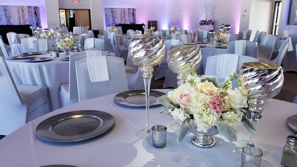 Pier B wedding lighting in two tone lavender. pin spots on flowers. decor by @thevaultduluth
