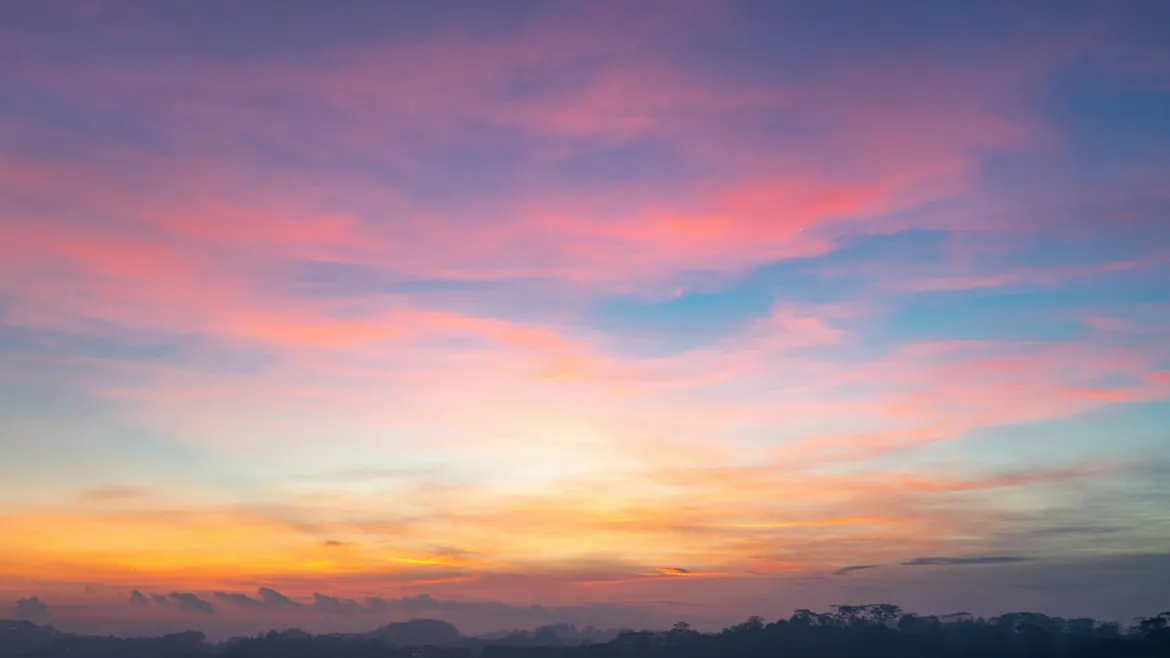 Colorful sunset sky with pink and blue clouds.