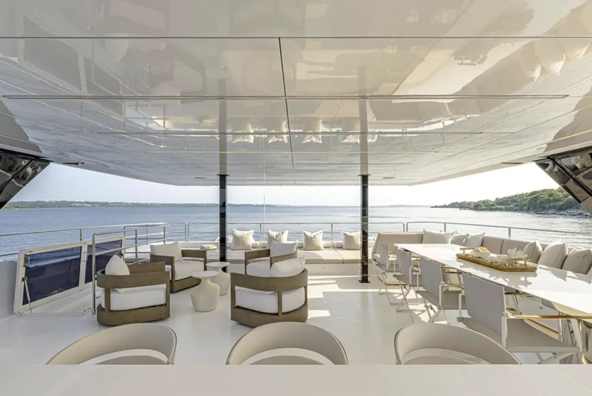 Luxurious yacht deck featuring modern seating, a dining area